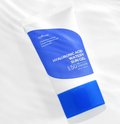 Blue and white tube of hyaluronic acid watery sun gel on a white background
